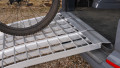 extra wide loading ramps resting on car with bike being loaded
