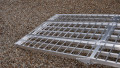 extra wide loading ramps resting on car, close up of foot end