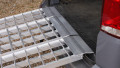extra wide loading ramps resting on car, close up of rest on connection