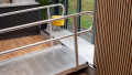 Wheelchair ramp with handrails in place resting on a step