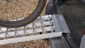 Push bike being pushed up our extra wide motorcycle loading ramps