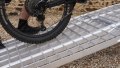 extra wide loading ramps resting on car with bike being loaded
