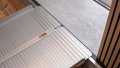 Extra wide folding wheelchair ramp resting on step, close up view of the rest on connection