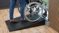 Wheelchair going up pair of rubber threshold ramps to gain access to garden