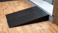 a pair of rubber threshold ramps used to overcome step in a home