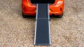 Telescopic dog ramp resting on the boot of a car