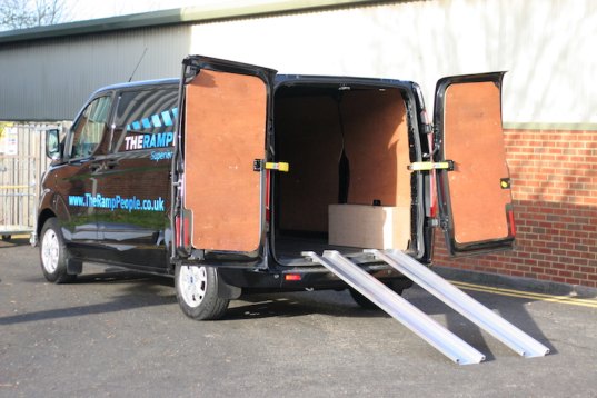 Aluminium channel ramps resting on a van