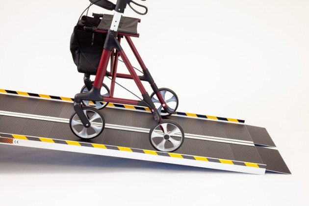 Rollator going up folding wheelchair ramp