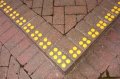 Yellow discs on pavement 
