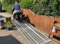 extra wide loading ramps on white background with bike being loaded