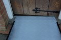 Fixed threshold ramp resting on door step 