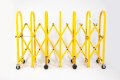 Yellow expandable safety barrier on wheels 