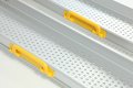 Yellow handles on telescopic wheelchair ramps 