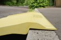 Yellow kerb ramp resting on kerb