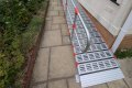 RollAble ramp with handrail providing access into a home