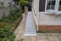 RollAble ramp with handrail on wooden decking