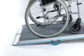 Manual wheelchair going up aerolight wheelchair ramp