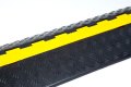 Black and yellow cable protector with chequered anti-slip surface 