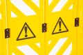 Yellow safety barrier with warning signs 