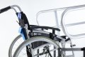 Manual wheelchair by handrails
