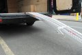 Curved loading ramp resting onto van 