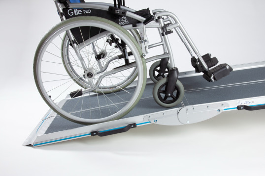 Manual wheelchair going up the wheelchair ramp 