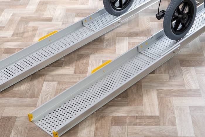 Telescopic wheelchair ramp with manual wheelchair going up Telescopic wheelchair ramp with manual wheelchair going up