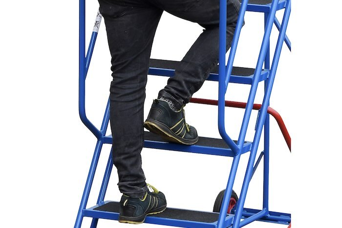 Person walking up steel ladder