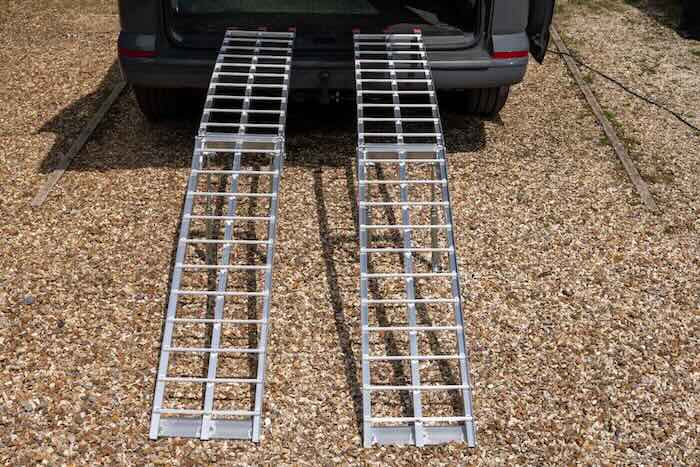 Pair of heavy duty folding loading ramps resting on van