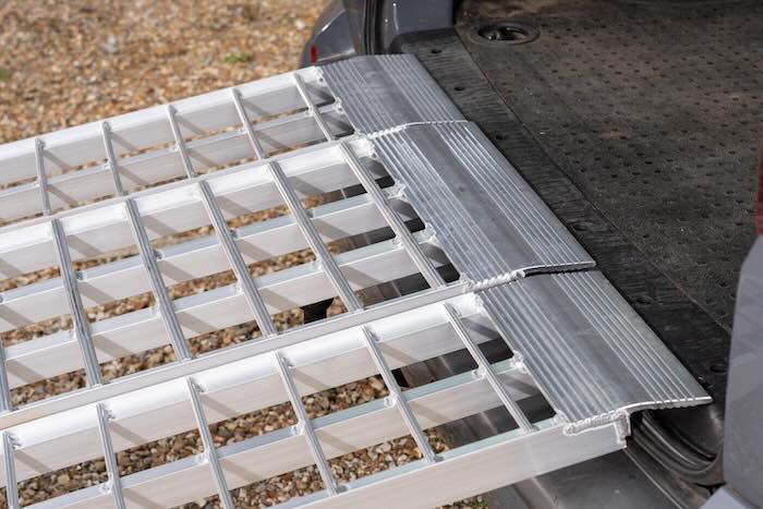 Motorcycle ramps resting on van 