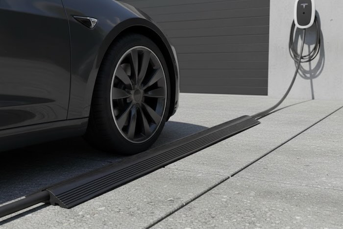 Cable protector protecting ev charging cable on driveway with car beside 