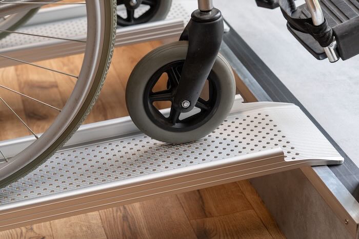 Pair of aluminium wheelchair ramps on a step