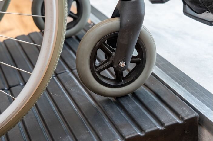 Wheelchair using ramp to overcome step