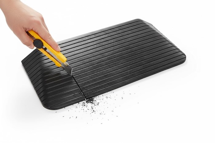Rubber ramp being cut to size 