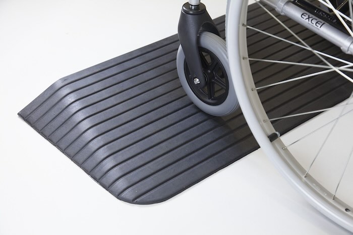 Wheelchair going up rubber ramp