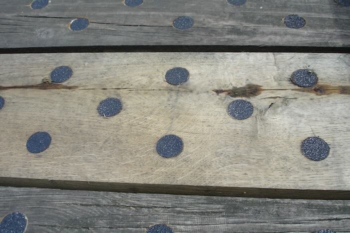 Black anti-slip discs on decking