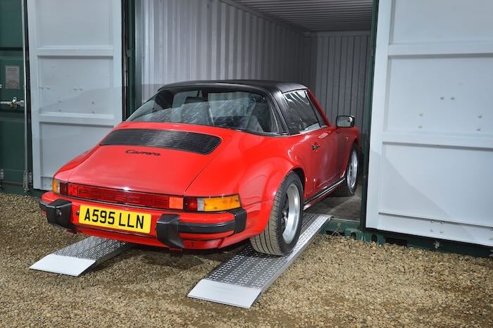 car being loaded into a container