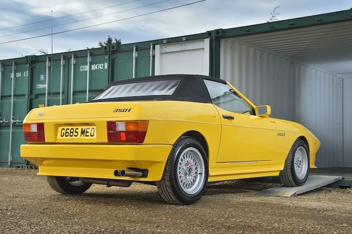 Car driving up aluminium ramps into a container