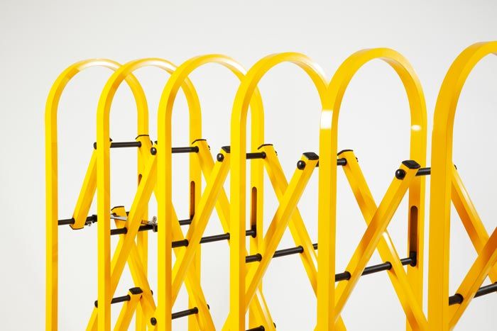 Yellow heavy duty expandable safety barrier on wheels Yellow heavy duty expandable safety barrier on wheels