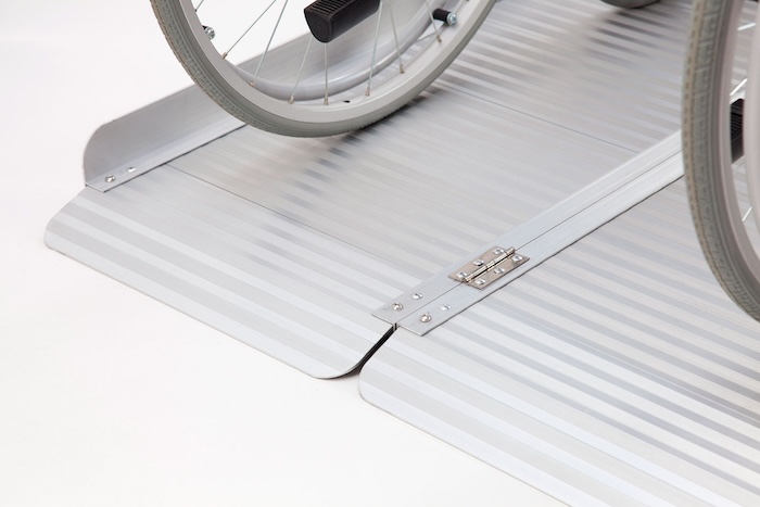Wheelchair going up aluminium wheelchair ramp