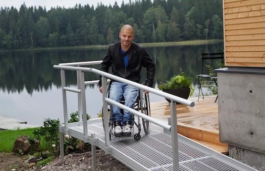 Wheelchair user going down a modular ramp 