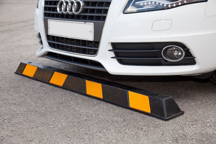Rubber wheel stop infront of a car 