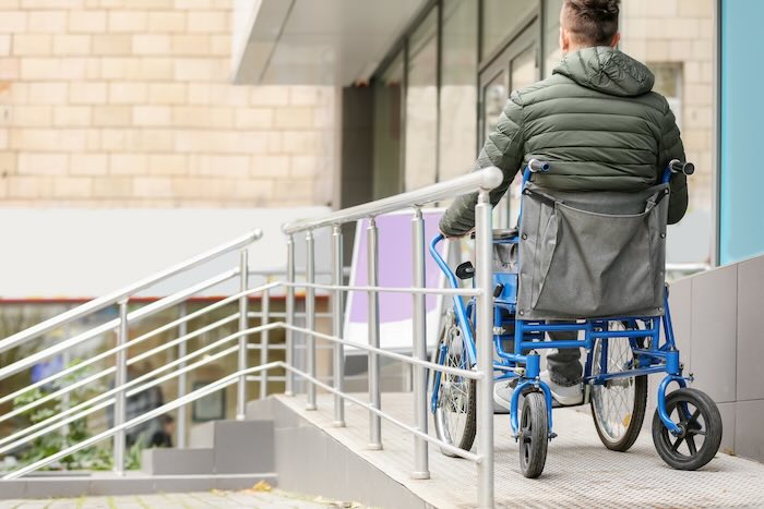 Wheelchair user going down Permanent Wheelchair Ramp 