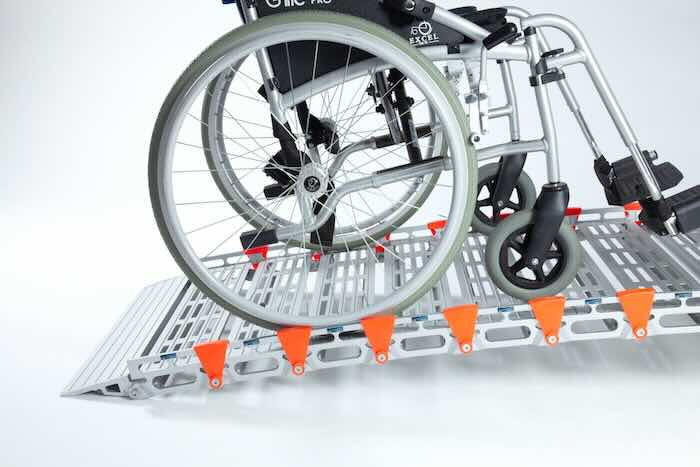 Wheelchair on rollable ramp 
