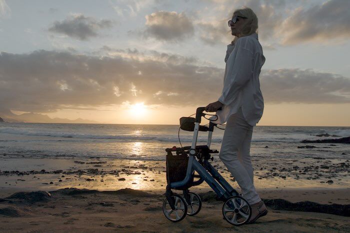 Lady walking on beach with Space lx rollator Lady walking on beach with Space lx rollator