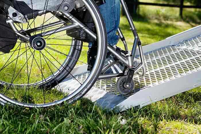 Wheelchair going up fixed van ramp