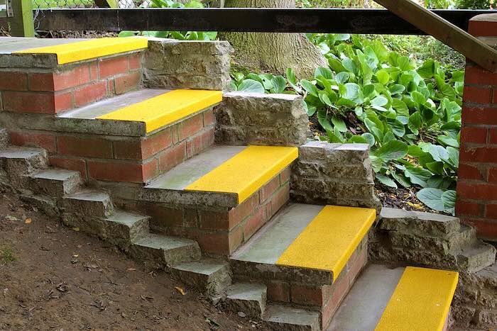 Yellow stair treads on concrete steps 
