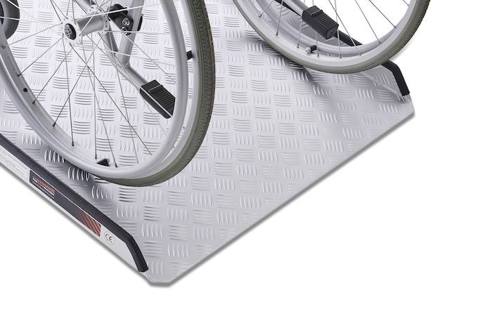 Wheelchair going up wheelchair ramp