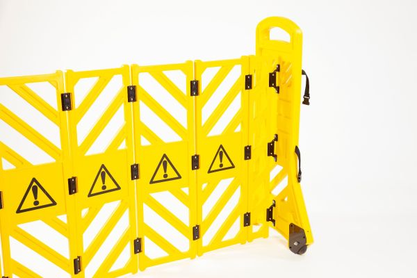 Yellow expandable barrier on wheels 