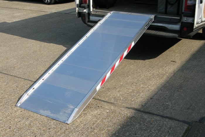 Heavy duty van ramp resting on van 